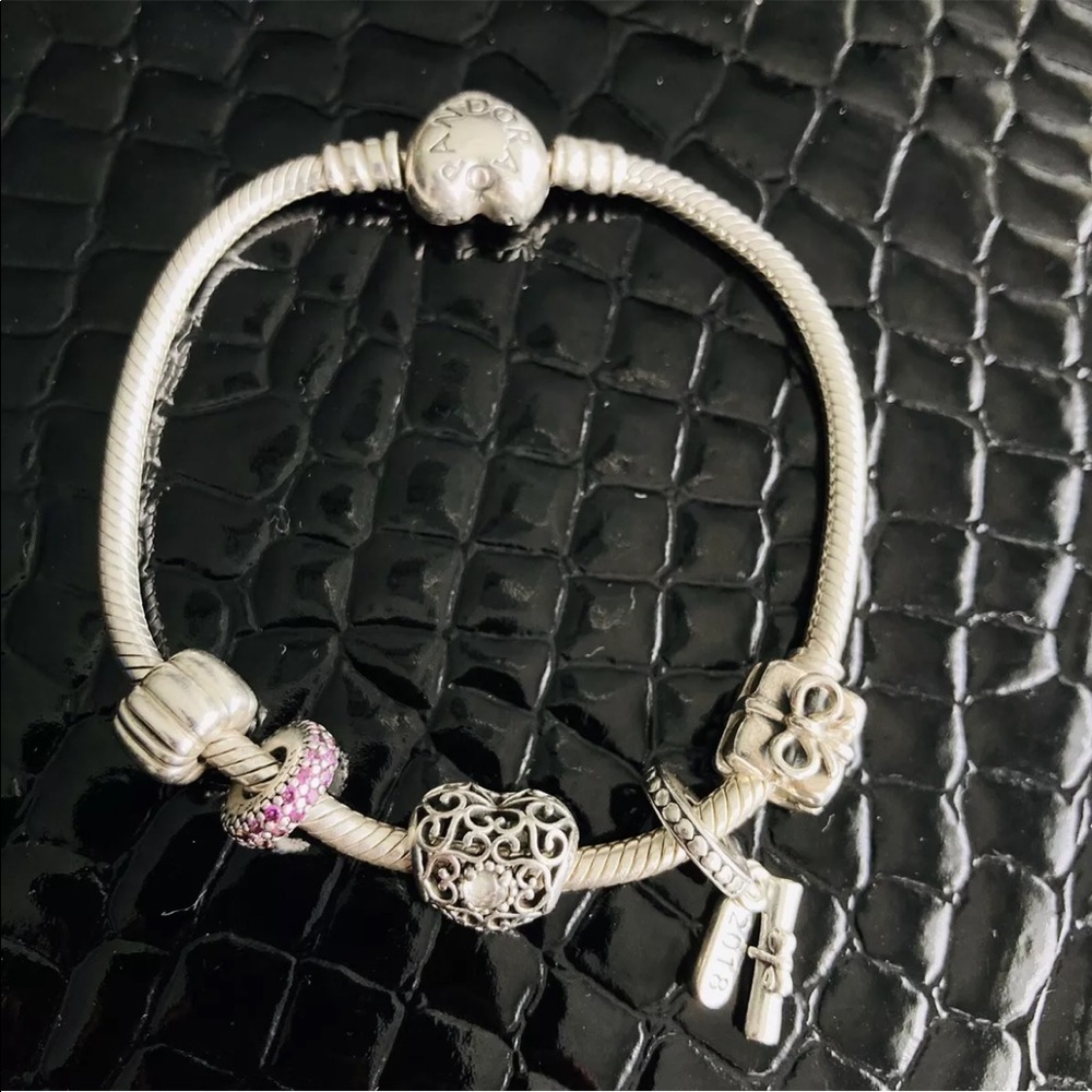 PANDORA STERLING SILVER CHARM BRACELET WITH 4 CHARMS AND 1 STOPPER